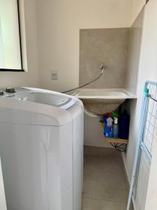 a bathroom with a tub and a washing machine at EcoStay Lençóis - apartamento in Lençóis +41 photos