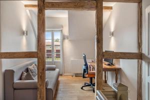 a living room with a desk and a couch at Hof Rosenstein in Helle