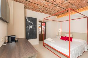 a bedroom with a canopy bed and a tv at Spazio Pardo in Catania