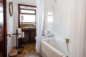 a white bathroom with a tub and a sink at La Guajira in Güime +21 photos