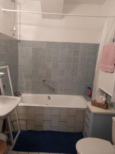 a bathroom with a tub and a toilet and a sink at La Maison Chez Karen in Séniergues +23 photos