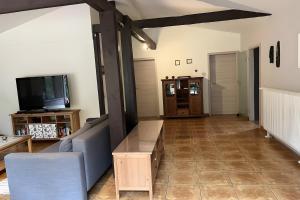 a living room with a couch and a tv at Ferienhaus Vossberg in Grabow