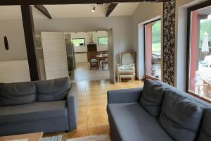 a living room with a couch and a dining room at Ferienhaus Vossberg in Grabow