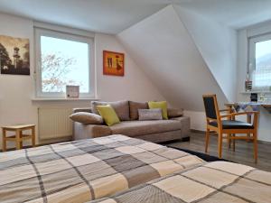 a bedroom with a bed and a couch at Ferienunterkunft Schrichten in Schmallenberg