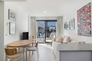 a living room with a couch and a table at Casa África in Zahara de los Atunes