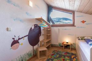 a bedroom with a wall with a cow on it at Moserhof Ferienwohnung Schartblick in Sarntal