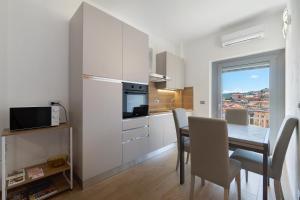 a kitchen and dining room with a table and chairs at Casa A Prima Vista Varazze in Varazze