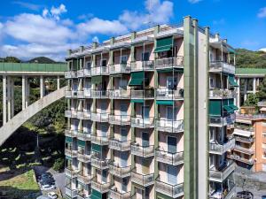an apartment building with balconies and a bridge at Casa A Prima Vista Varazze in Varazze