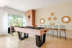 a living room with a ping pong table in it at Villa with pool and beach access in Ben Slimane