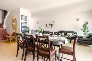 a dining room with a table and chairs at Villa with pool and beach access in Ben Slimane