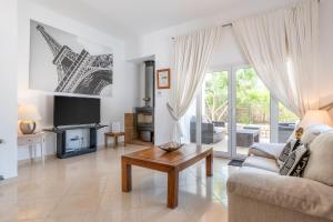 a living room with a couch and a table at Villa Luca in Cala d´Or