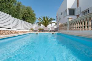 a swimming pool in the backyard of a house at Villa Luca in Cala d´Or