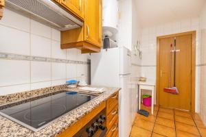 a kitchen with a sink and a refrigerator at Apartament Garrota in Olp +18 photos