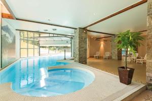 a large swimming pool in the middle of a house at L'Izard Piscine, Jacuzzi, Parking in Cauterets
