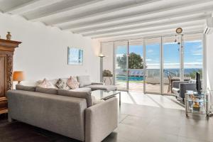 a living room with a couch and a view of the ocean at Casa Green in Mijas Costa
