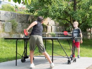 a woman and a boy playing ping pong at Ferienhof Henn in Weikersheim