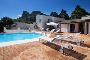 a villa with a swimming pool and a house at Casa Le Rocce San Pantaleo in San Pantaleo
