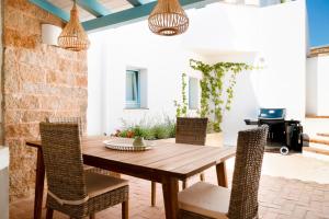 a dining room with a wooden table and chairs at Casa Le Rocce San Pantaleo in San Pantaleo