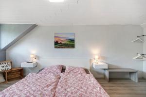 a bedroom with a bed and two lights on the wall at Casa Renata in Schüller