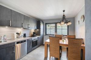 a kitchen with a table and a dining room at Casa Renata in Schüller