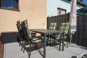 a black table and chairs on a patio at Casa Renata in Schüller +18 photos