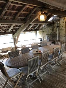 a large wooden table and chairs in a room at Chambres D'hôtes du Pentadou in Felzins