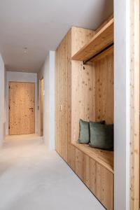a room with wooden walls and a bench with two pillows at Vronis Lodge in Hart im Zillertal