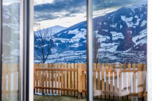 a window with a view of a snow covered mountain at Vronis Lodge in Hart im Zillertal