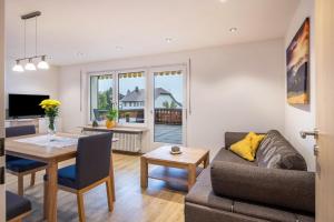 a living room with a couch and a table at Ferienwohnung Nr 5 Sonnenschein in Höchenschwand
