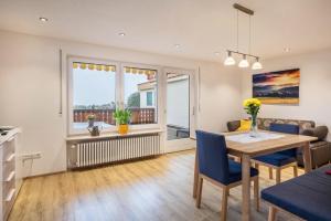 a dining room and living room with a table and chairs at Ferienwohnung Nr 5 Sonnenschein in Höchenschwand