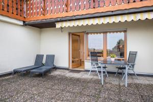 a patio with a table and chairs and a glass door at Ferienwohnung Nr 5 Sonnenschein in Höchenschwand