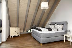 a bedroom with a bed and a wooden ceiling at Panorama Atemlos Kuckucks Chillout in Oberibach