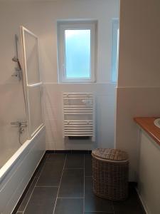 a bathroom with a tub and a sink and a window at Chambres Er Vingle - Locmariaquer in Locmariaquer +36 photos