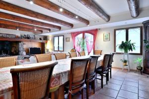 a dining room with a large table and chairs at Les Hélianthèmes in Guchen