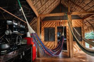 a room with a hammock in a cabin at Wildlife Lodge Cahuita in Cahuita +88 photos