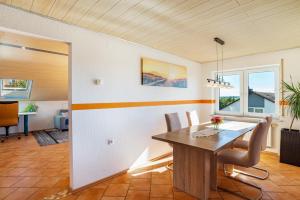 a dining room with a wooden table and chairs at Hügelblick Oase in Kraichtal