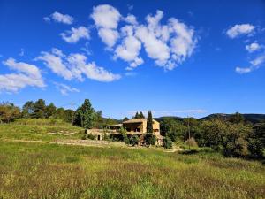 an old house on a hill in a field at Masia Caltiku in Els Ranxos de Bonany