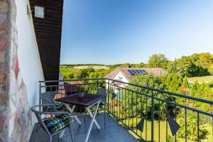 a patio with a table and chairs on a balcony at Hügelblick Oase in Kraichtal