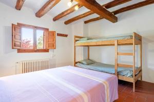 a bedroom with a bunk bed and a window at Masia Caltiku in Els Ranxos de Bonany +27 photos