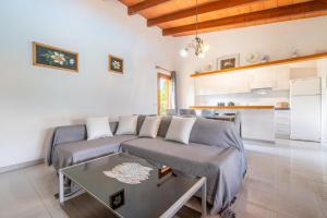 a living room with a couch and a table at Can Jaume Des Carritxó in Felanitx