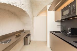 a kitchen with a counter with a sink and a microwave at Spazio Pardo in Catania