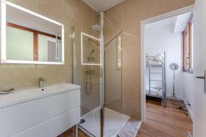 a bathroom with a sink and a shower at Appartement Rose Mousse - Abatilles in Arcachon
