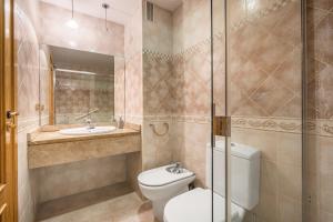 a bathroom with a toilet and a sink and a shower at Central, Spacious Parking in Granada +16 photos