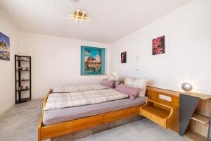 a bedroom with a bed with a wooden bed frame at Hund und Kind Appartment in Oberndorf am Neckar