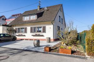 a house with a car parked in front of it at Hund und Kind Appartment in Oberndorf am Neckar
