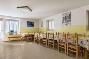 a dining room with wooden tables and chairs at Casa Vacanza Zambotti in Vermiglio