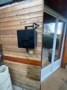 a wooden wall with a tv and a window at Maison Donasete voyageurs in Vieille-Brioude