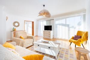 a living room with a couch and a coffee table at Ty Corniche - 50m de la plage in Bénodet