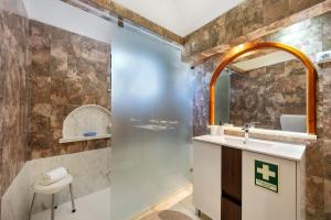 a bathroom with a sink and a mirror at Casa 54 in Valverde +16 photos