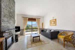 a living room with a couch and a fireplace at Casa 54 in Valverde